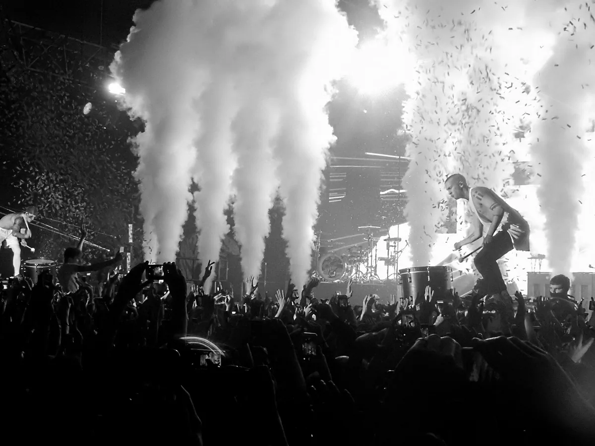 Twenty One Pilots performing live under stage lights